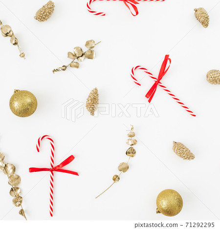 Christmas winter composition. Golden decoration and candy canes on white. Flat lay, top view. New Year holiday Christmas winter composition. Golden decoration and candy canes on white. Flat lay, top view. New Year holiday 71292295