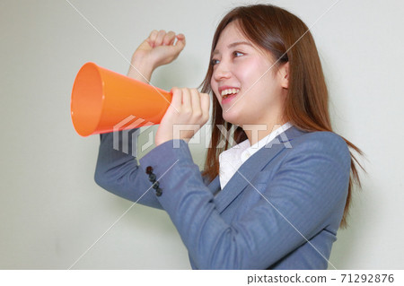 A woman who raises her right hand and cheers A woman who raises her right hand and cheers 71292876