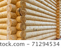corner of wooden house made of natural logs 71294534