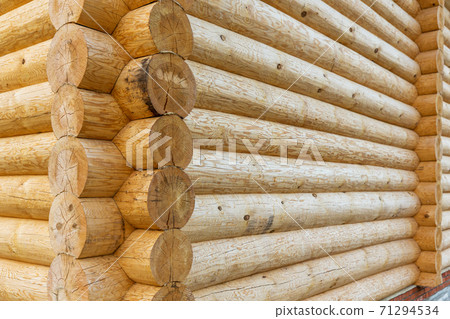corner of wooden house made of natural logs 71294534