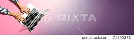 Person using a laptop computer 71295278