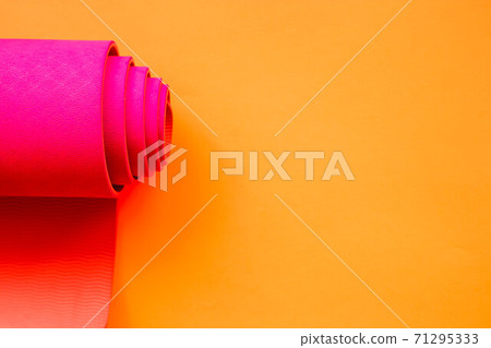 bright pink ultramarine yoga mat on orange background 71295333
