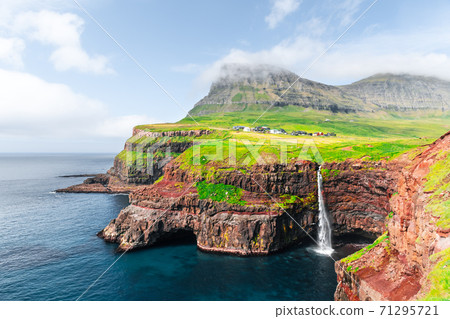 Mulafossur waterfall in Gasadalur, Vagar Island of the Faroe Islands. Mulafossur waterfall in Gasadalur, Vagar Island of the Faroe Islands. 71295721