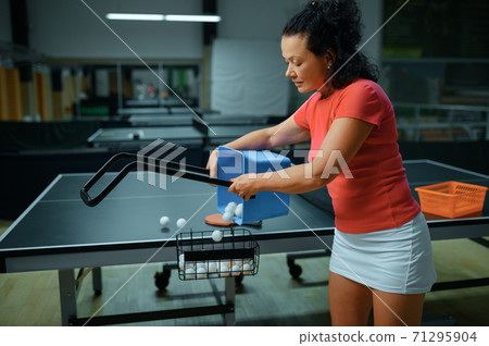 Woman with basket of ping pong balls, table tennis 71295904