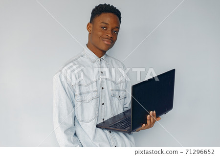 Handsome black man standing on a blue background Handsome black man standing on a blue background 71296652
