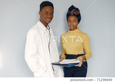 Black doctor in a white uniform with a stethoscope 71296690