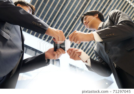 A businessman exchanging business cards A businessman exchanging business cards 71297045