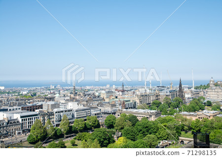 The cityscape of Edinburgh overlooking Edinburgh Castle and the sea in the distance 71298135