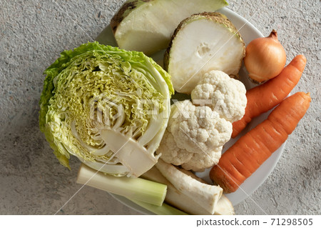 Ingredients for preparing a vegetable broth or soup - carrots, Savoy cabbage, onions, cauliflower, celery root, parsley root and other Ingredients for preparing a vegetable broth or soup - carrots, Savoy cabbage, onions, cauliflower, celery root, parsley root and other 71298505