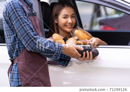 asian woman making contactless payment for grocery asian woman making contactless payment for grocery 71299126