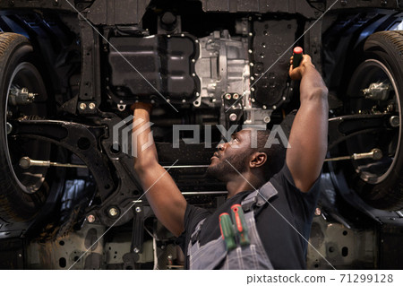 concentrated auto mechanic man repairing car hood alone 71299128