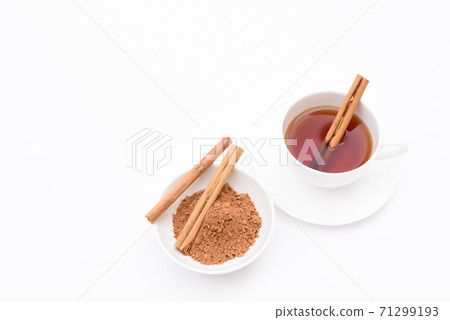 Black tea and cinnamon brewed in a tea cup white background Black tea and cinnamon brewed in a tea cup white background 71299193