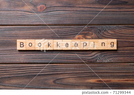 bookkeeping word written on wood block. bookkeeping text on table, concept 71299344