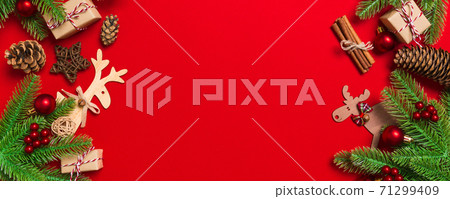 Top view of Christmas decorations on red background. Banner New Year holiday concept with copy space 71299409