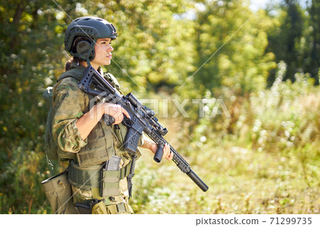 strong brave female army soldier with rifle machine gun standing in the forest strong brave female army soldier with rifle machine gun standing in the forest 71299735