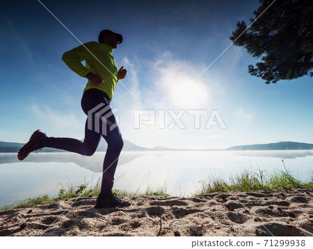Morning condition workout on beach. Silhouette run 71299938