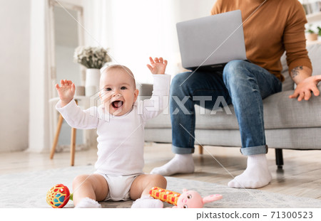 Baby Toddler Shouting Bothering Father While He Working At Home Baby Toddler Shouting Bothering Father While He Working At Home 71300523