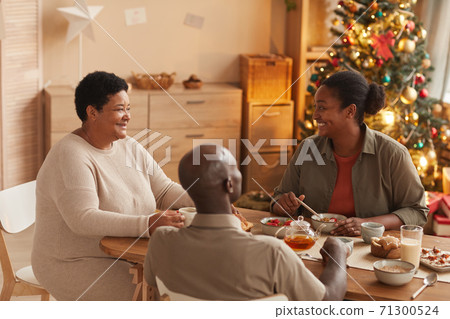 Happy African-American Family Enjoying Breakfast Happy African-American Family Enjoying Breakfast 71300524