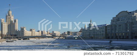 Moscow cityscape in winter sunny day. Stalinist skyscraper, Moskva river had been covered by ice floes. Kotelnicheskaya and Raushskaya embankment. Bolshoy Ustinsky Bridge. Moscow cityscape in winter sunny day. Stalinist skyscraper, Moskva river had been covered by ice floes. Kotelnicheskaya and Raushskaya embankment. Bolshoy Ustinsky Bridge. 71301792