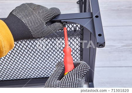 Building flat packed furniture DIY with help of screwdriver at home. 71301820