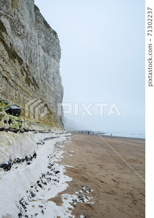 Misty morning fog landscape on the cliffs of Etretat in France 71302237