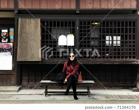 Happy woman tourist enjoy view in old twon street city of Takayama, Japan 71304170