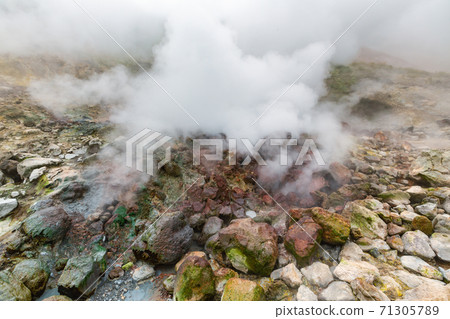 Picturesque view of volcanic landscape, aggressive hot spring, eruption fumarole, gas-steam activity in crater active volcano 71305789