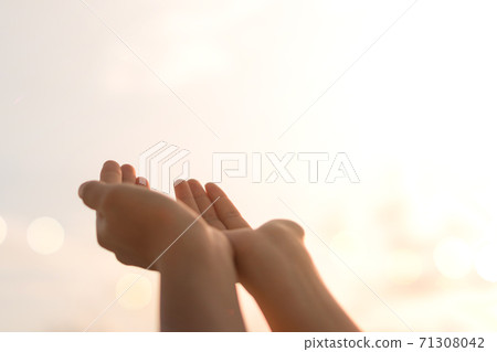 Woman hands place together like praying in front of nature green background. Woman hands place together like praying in front of nature green background. 71308042