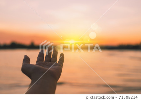 Woman hands reach out to the sky like praying in front of sky. Woman hands reach out to the sky like praying in front of sky. 71308214