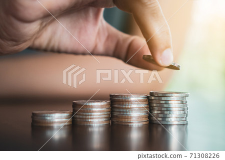 Gold coins on table and green nature bokeh background. Gold coins on table and green nature bokeh background. 71308226