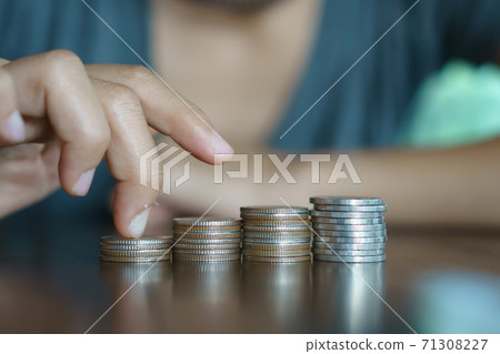 Gold coins on table and green nature bokeh background. Gold coins on table and green nature bokeh background. 71308227