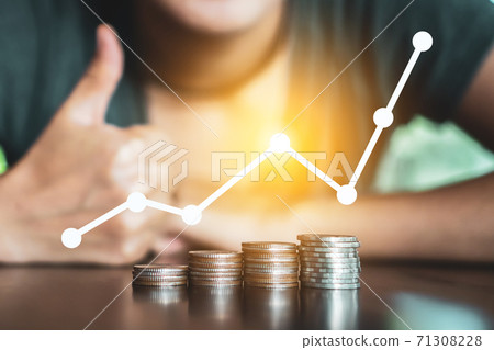Business financial successful concept with icon growth graph uptrend and Gold coins money stack on table. Business financial successful concept with icon growth graph uptrend and Gold coins money stack on table. 71308228