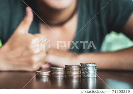 Gold coins on table and green nature bokeh background. Gold coins on table and green nature bokeh background. 71308229