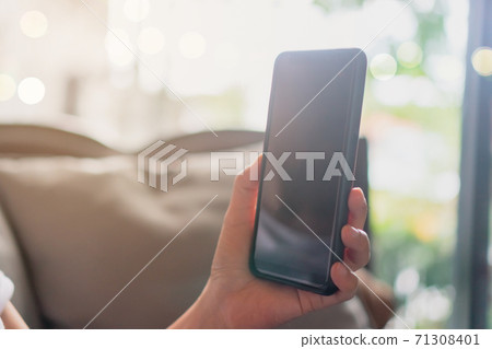 Womanhand using smartphone to do work business, social network, communication in public cafe work space. Womanhand using smartphone to do work business, social network, communication in public cafe work space. 71308401