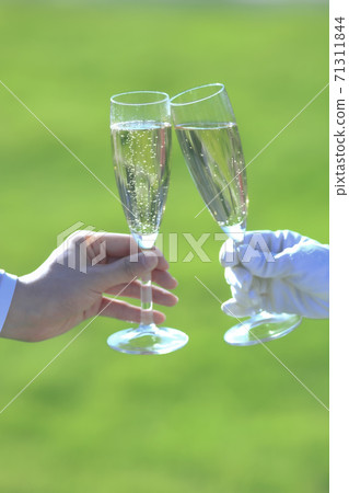 Hand of the bride and groom drinking with champagne Hand of the bride and groom drinking with champagne 71311844