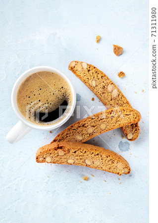 Cantucci. Traditional Italian almond biscuits with a cup of coffee Cantucci. Traditional Italian almond biscuits with a cup of coffee 71311980
