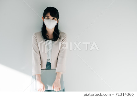 Business woman in a masked suit Business woman in a masked suit 71314360