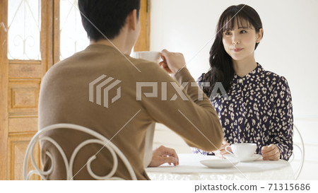 年輕的夫婦在一家咖啡店聊天 71315686