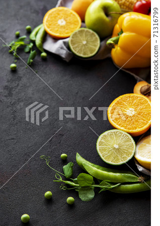 Healthy food. Vegetables and fruits on a black concrete background. Healthy food. Vegetables and fruits on a black concrete background. 71316799