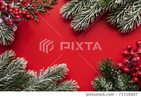 Christmas red decorations, fir tree branches on red background Christmas red decorations, fir tree branches on red background 71316807
