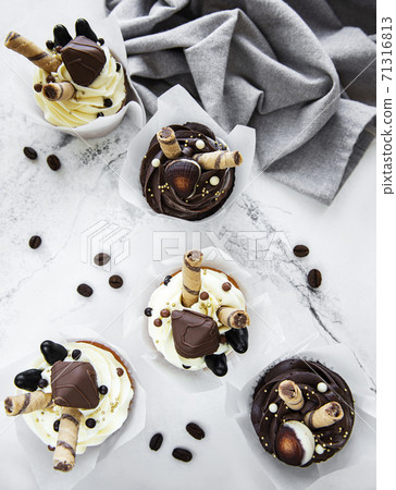 Chocolate cupcakes on white marble background Chocolate cupcakes on white marble background 71316813