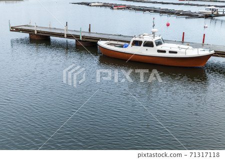 Small motor boat is mooter at floating pontoon pier 71317118