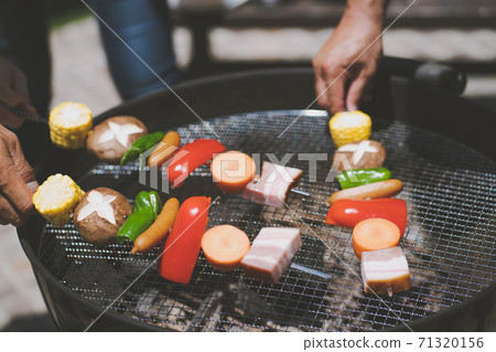 BBQ, grilling on skewer, spit-roasting 71320156