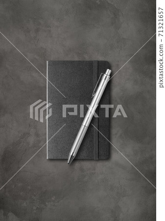 Black closed notebook with a pen on dark concrete background Black closed notebook with a pen on dark concrete background 71321657