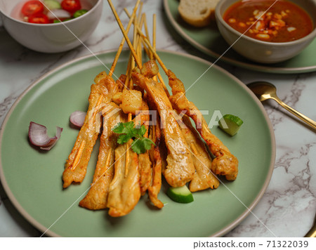 Grilled pork satay (Moo Satay) served with peanut sauce and side dish Grilled pork satay (Moo Satay) served with peanut sauce and side dish 71322039