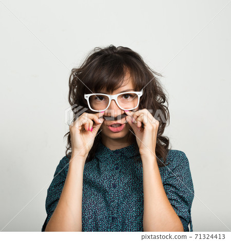Portrait of beautiful businesswoman with eyeglasses against white background 71324413