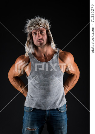Strong and fit. Bodybuilder wear fur hat in casual style black background. Bodybuilder Strong and fit. Bodybuilder wear fur hat in casual style black background. Bodybuilder 71325279