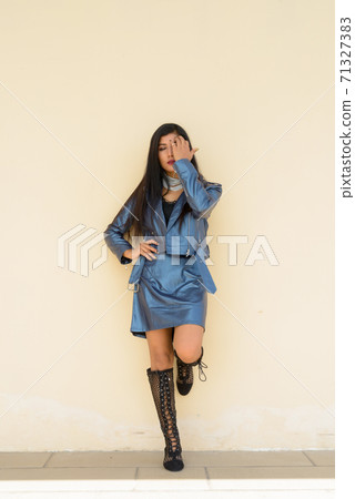 Full length shot of beautiful young woman standing outdoors Full length shot of beautiful young woman standing outdoors 71327383