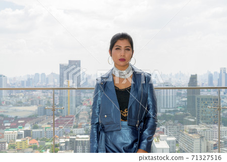 Portrait of beautiful young woman outdoors at rooftop 71327516