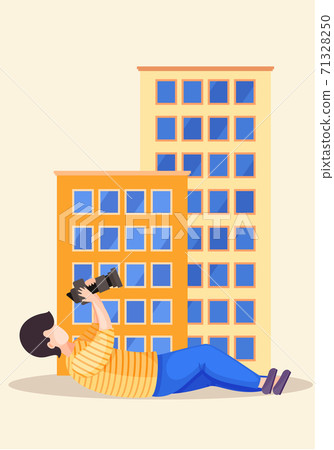 The guy lying and adjusting the lens. Photographer with camera takes pictures of a buildings The guy lying and adjusting the lens. Photographer with camera takes pictures of a buildings 71328250